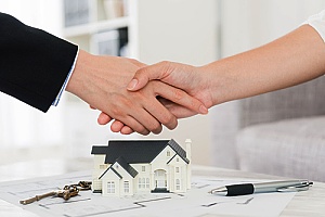 a handshake during escrow between the real estate agent and seller